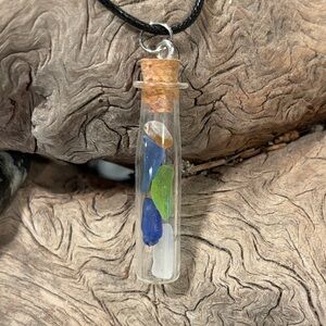 Sea glass jar pendant with cork stopper on 18” black cord.